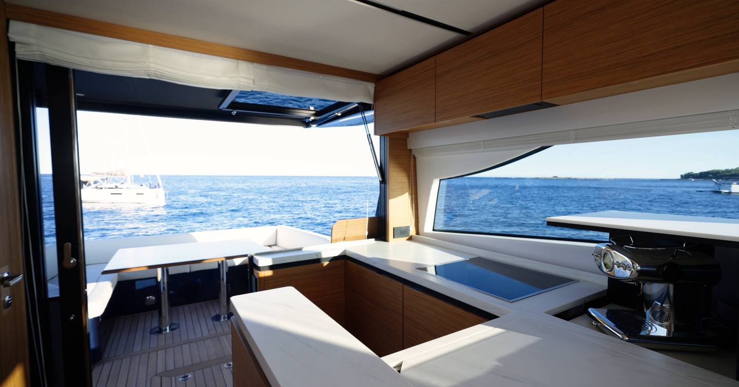 Solaris-Power-60-Coupe-Review-galley-open-to-cockpit-with-folding-door-and-sea-view