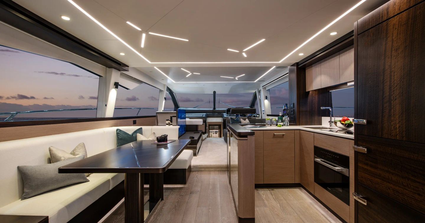 Sunseeker Manhattan 68 motor yacht interior with L-shaped sofa and galley