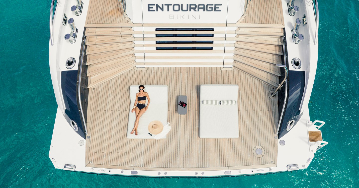 Aerial view of superyacht Entourage beach club with woman lying on sunpad