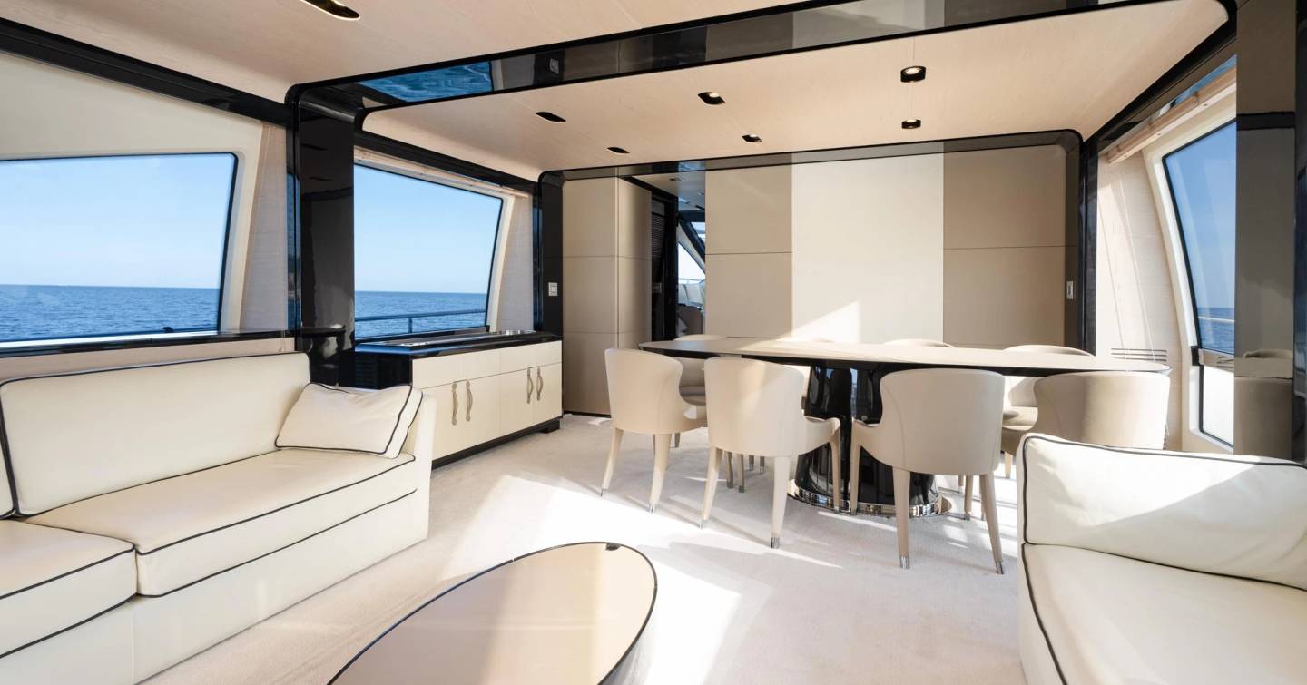 Motor Yacht Trinidad saloon with white furniture and dining area