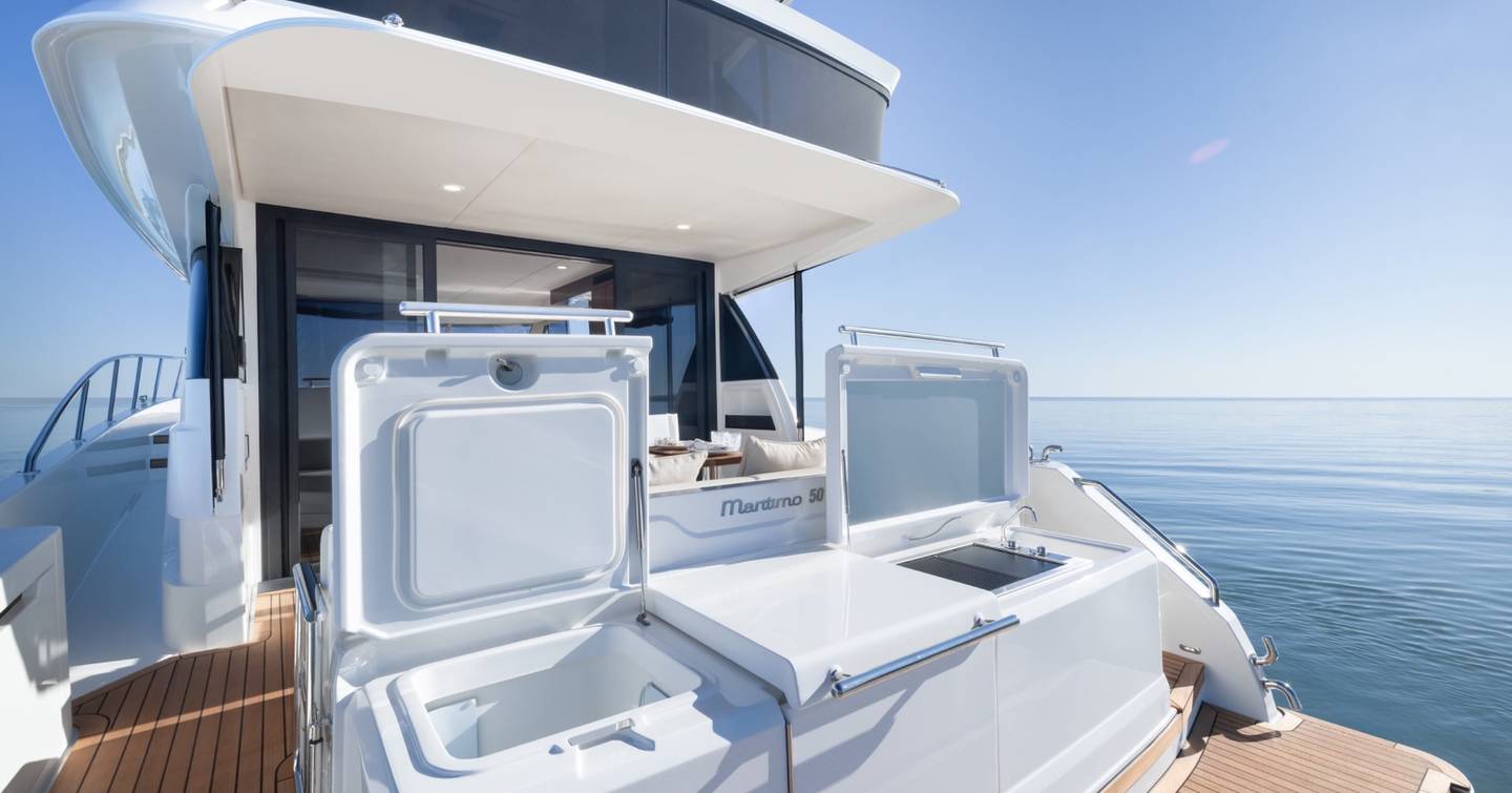 Maritimo M50 aft cockpit wet bar with open storage lockers, sink and preparation area