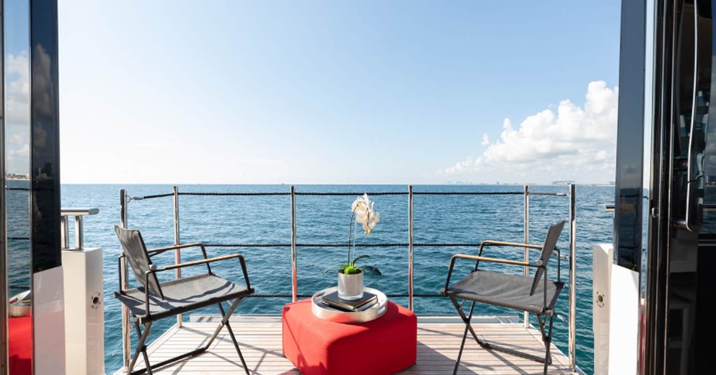 Motor yacht Fifty Shades fold down balcony with seating area and sea views