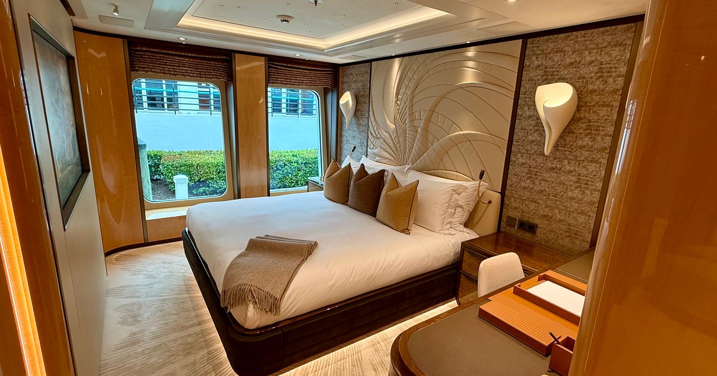 VIP guest cabin on the Amels 242 Casino Royale showing the double bed aligned with large hull windows.