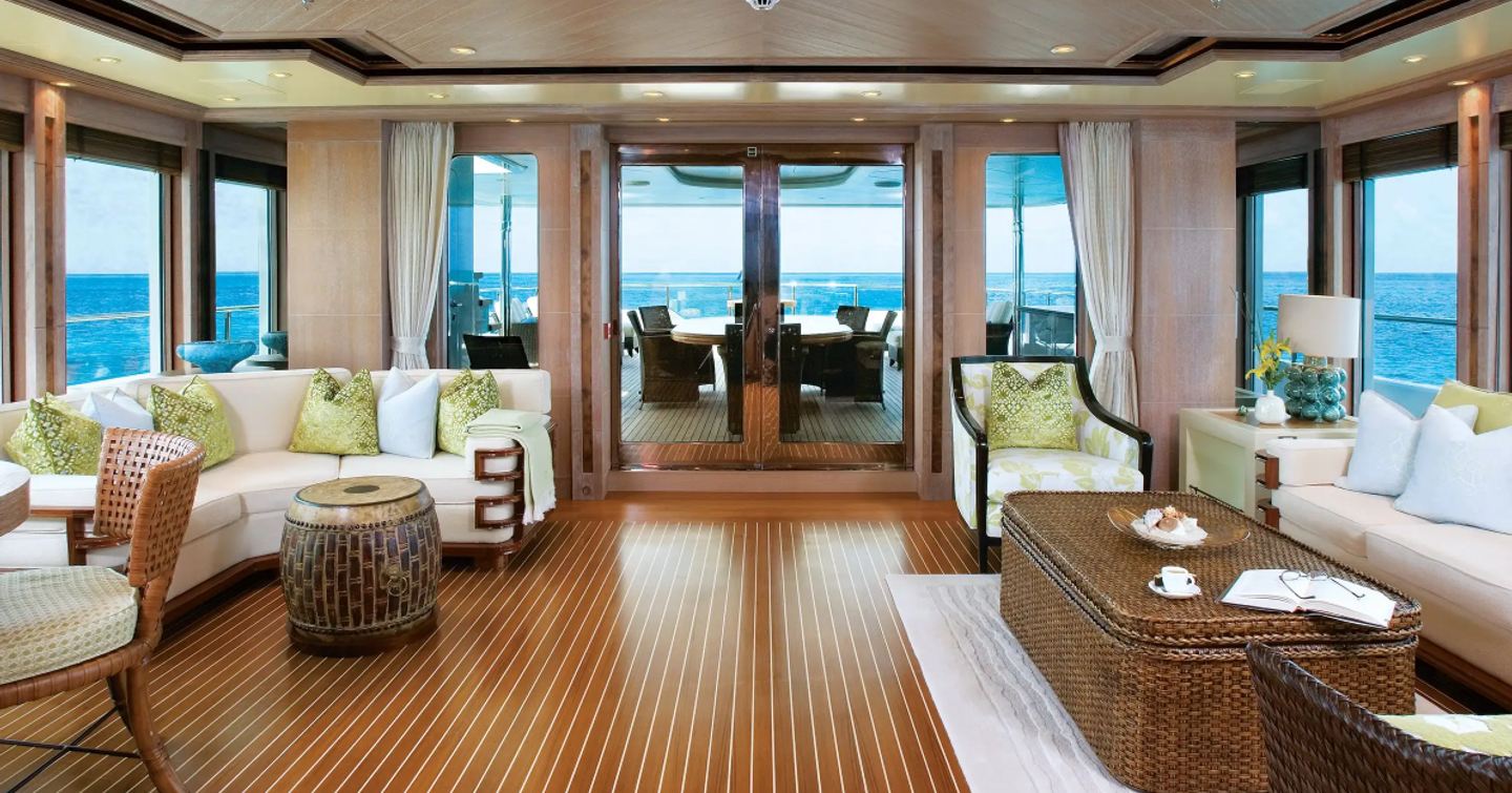 Superyacht Perle Bleue sky lounge with curved seating and large coffee table 