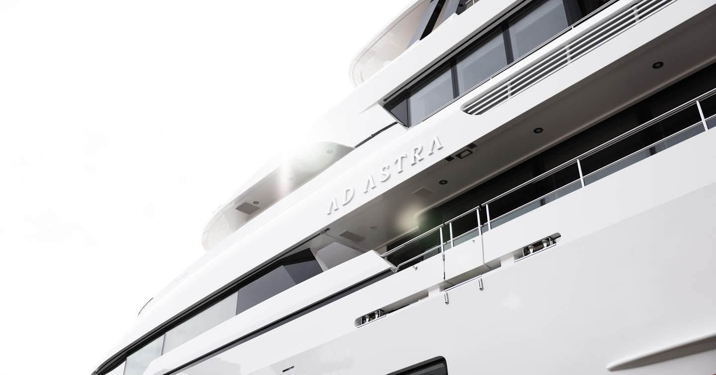 Motor yacht Ad Astra's nameplate on the stern, with white exterior