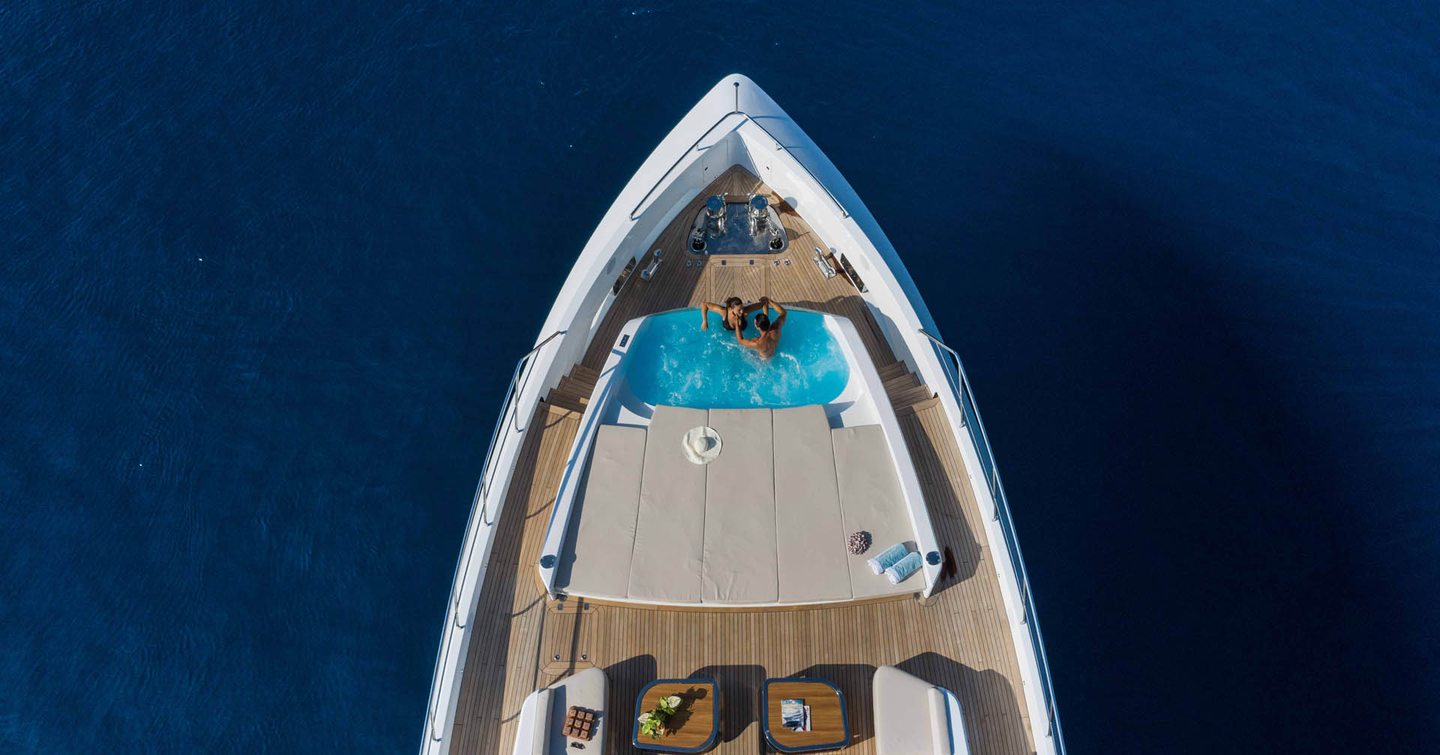 Aerial view of Mangusta GranSport 33 motor yacht foredeck with infinity pool and sunpads 