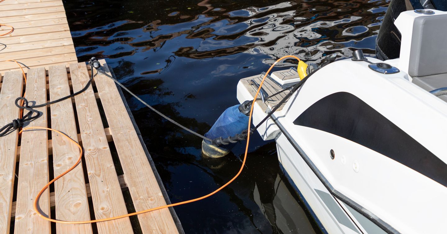 yacht hooked up to shore power in marina