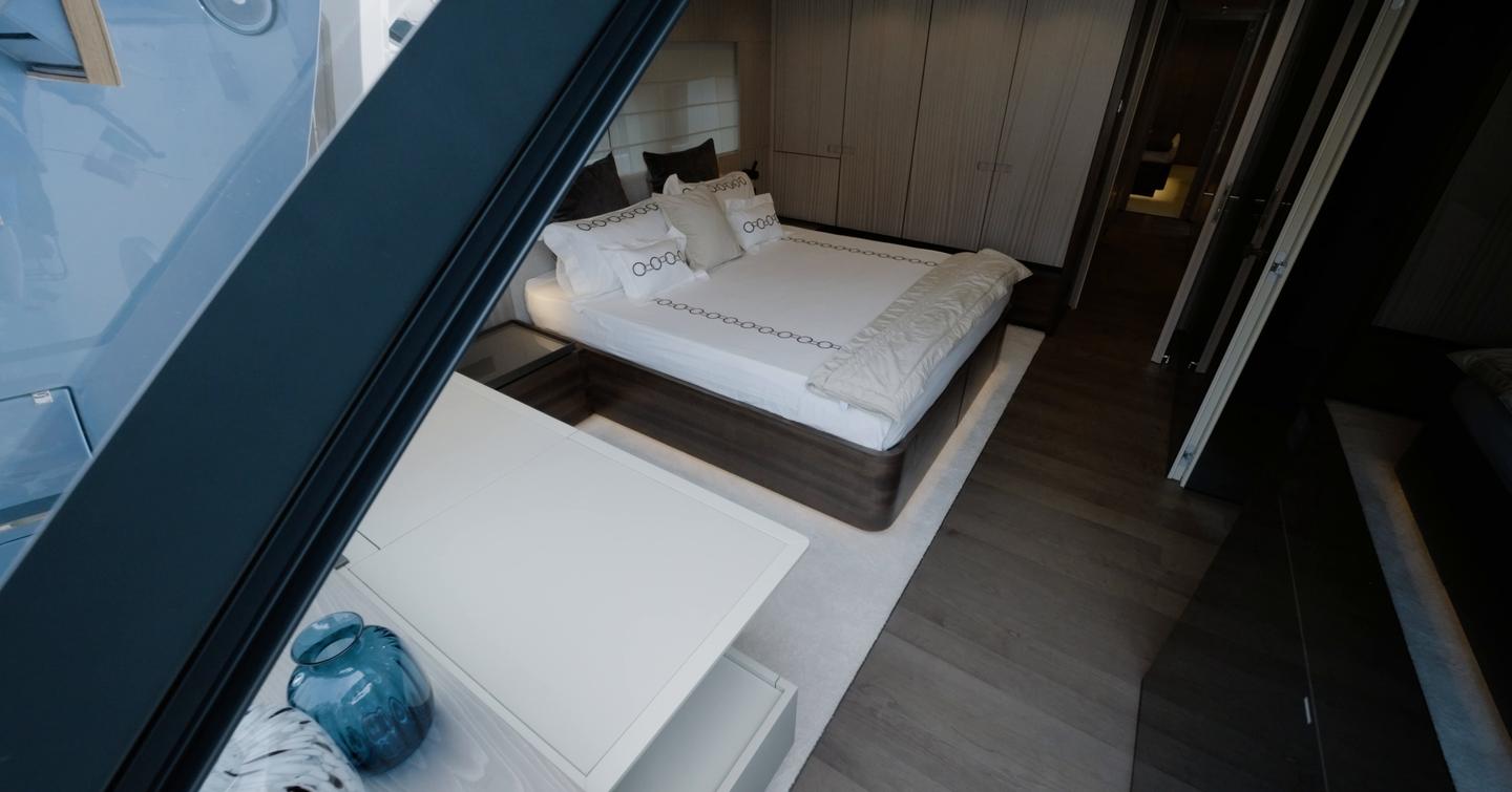 Owner suite on the Manda S07 Berlinetta featuring bureau below stern window and walkaround double berth