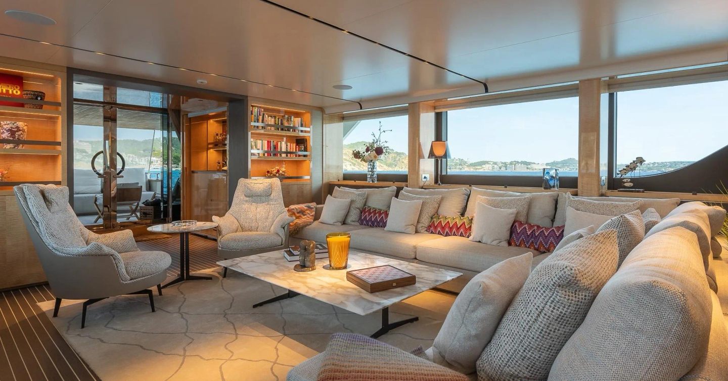 Sanlorenzo SD126 Motor Yacht Kia Ora main saloon with beige L-shaped sofa and warm lighting