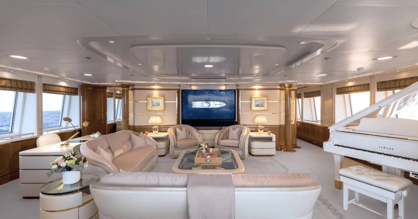 Superyacht Olympus upper skylounge with pink seating and grand piano