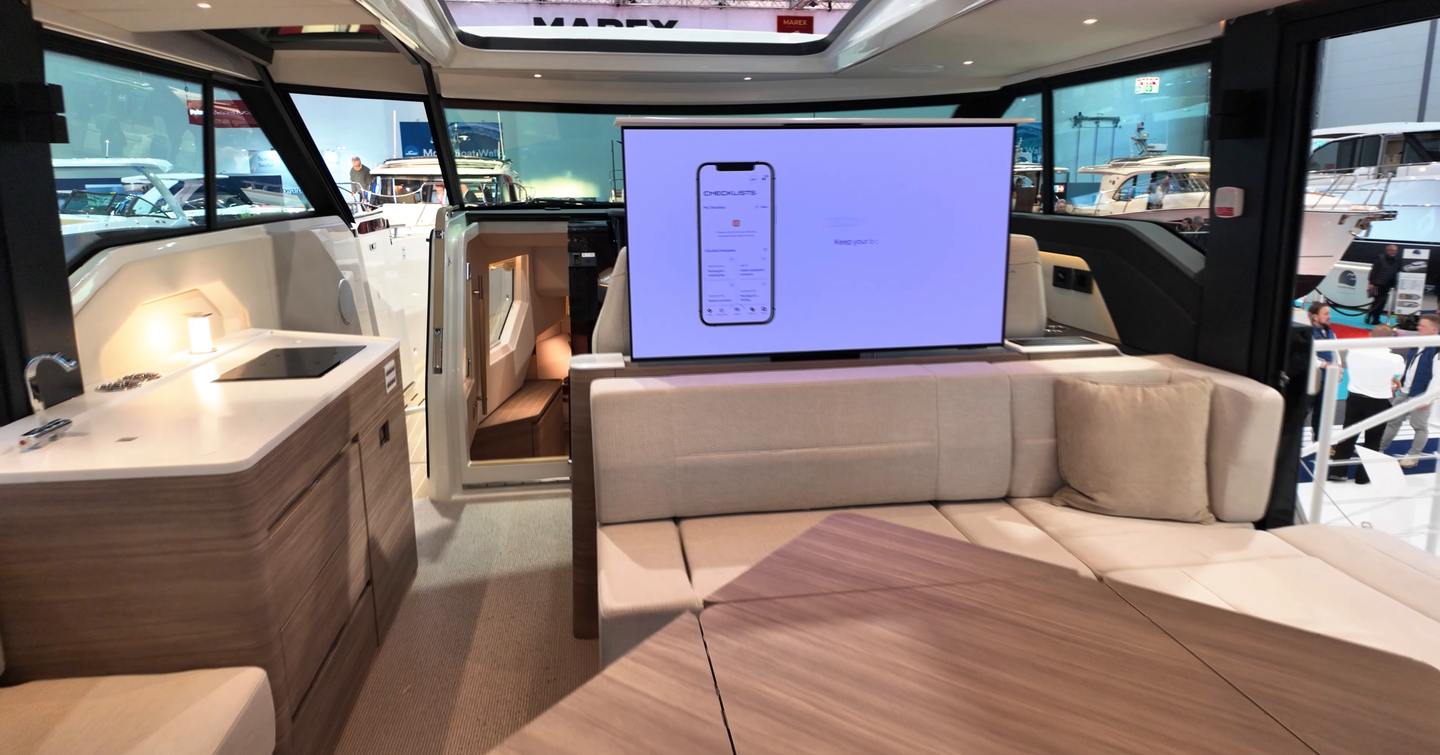 Saxdor-460-GTC-Review-main-saloon-with-dining-table-and-rising-tv