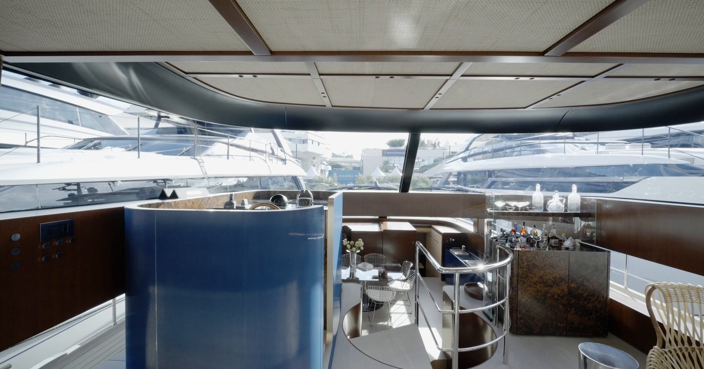 Sanlorenzo SHE helm station with panoramic glazing and view over the dining area
