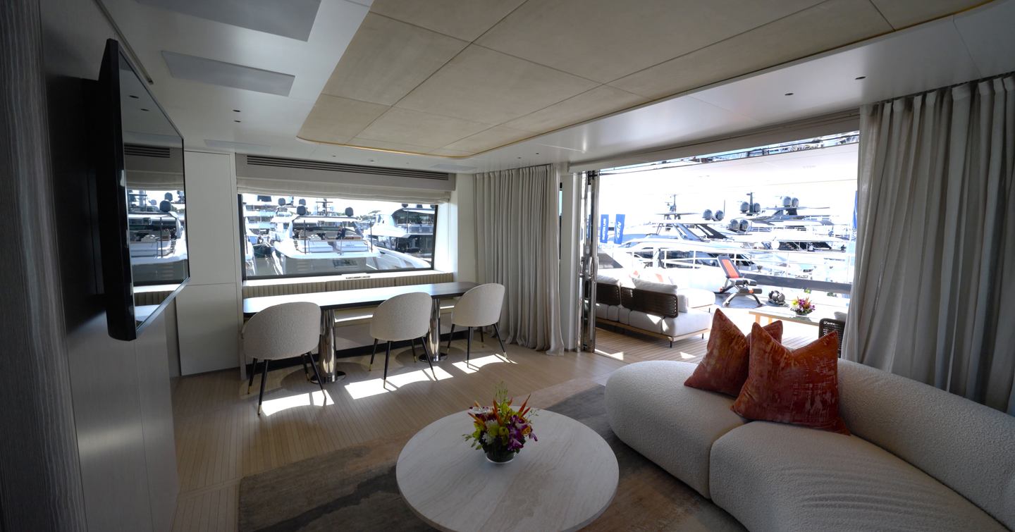Benetti Oasis 34M upper saloon with lounge seating, dining table and direct access to the bridge deck aft.