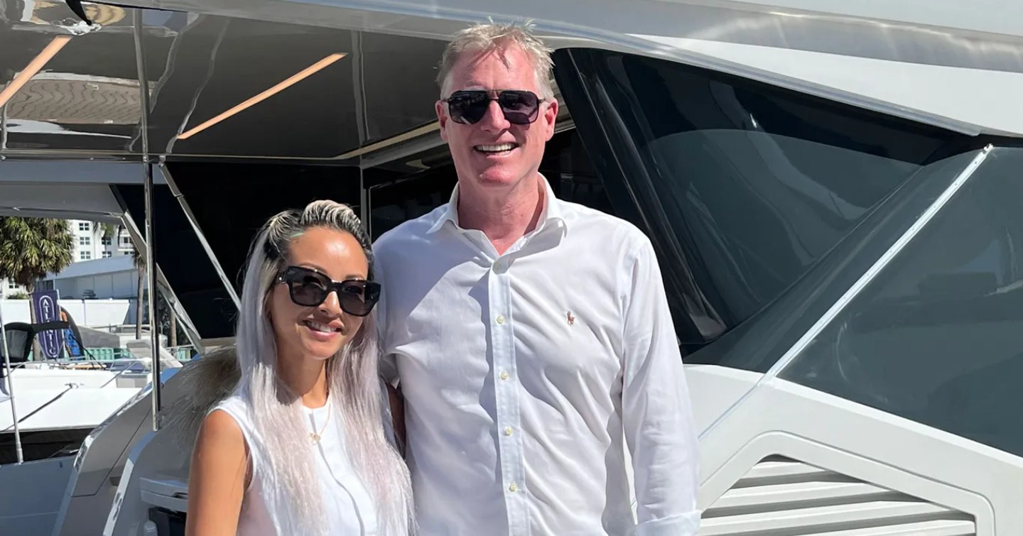 Two members of Pearl Yachts team wearing sunglasses in front ot motor yacht.