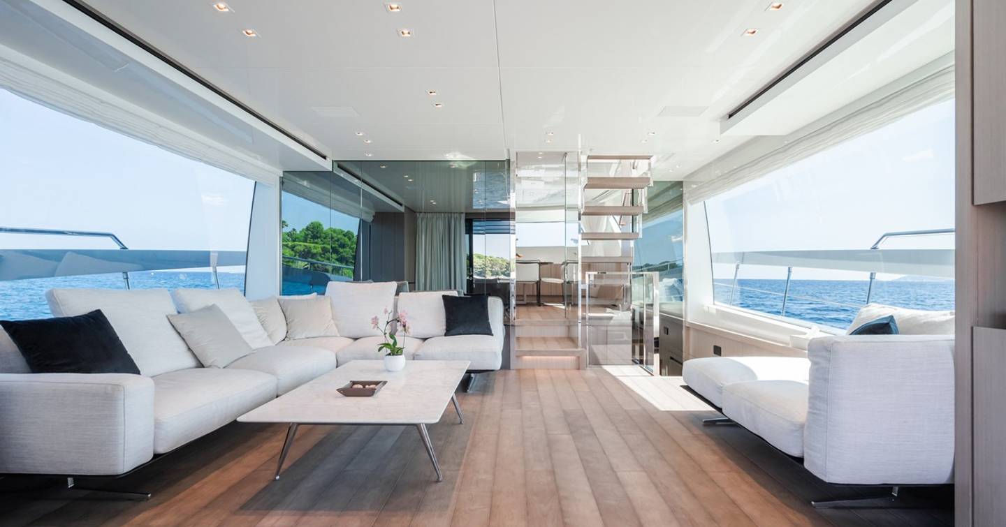 Motor yacht Fitline main saloon with white L-shaped sofa