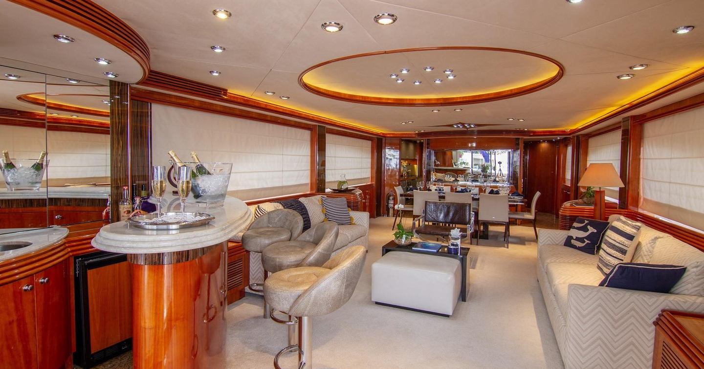 Motor Yacht #OMG main saloon with white furniture, bar area and dining table