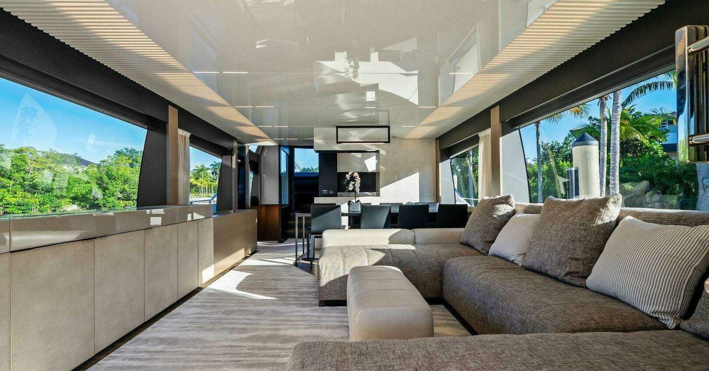 Ferretti 780 Motor Yacht Sunsation saloon with U-shaped brown sofa and forward dining area 