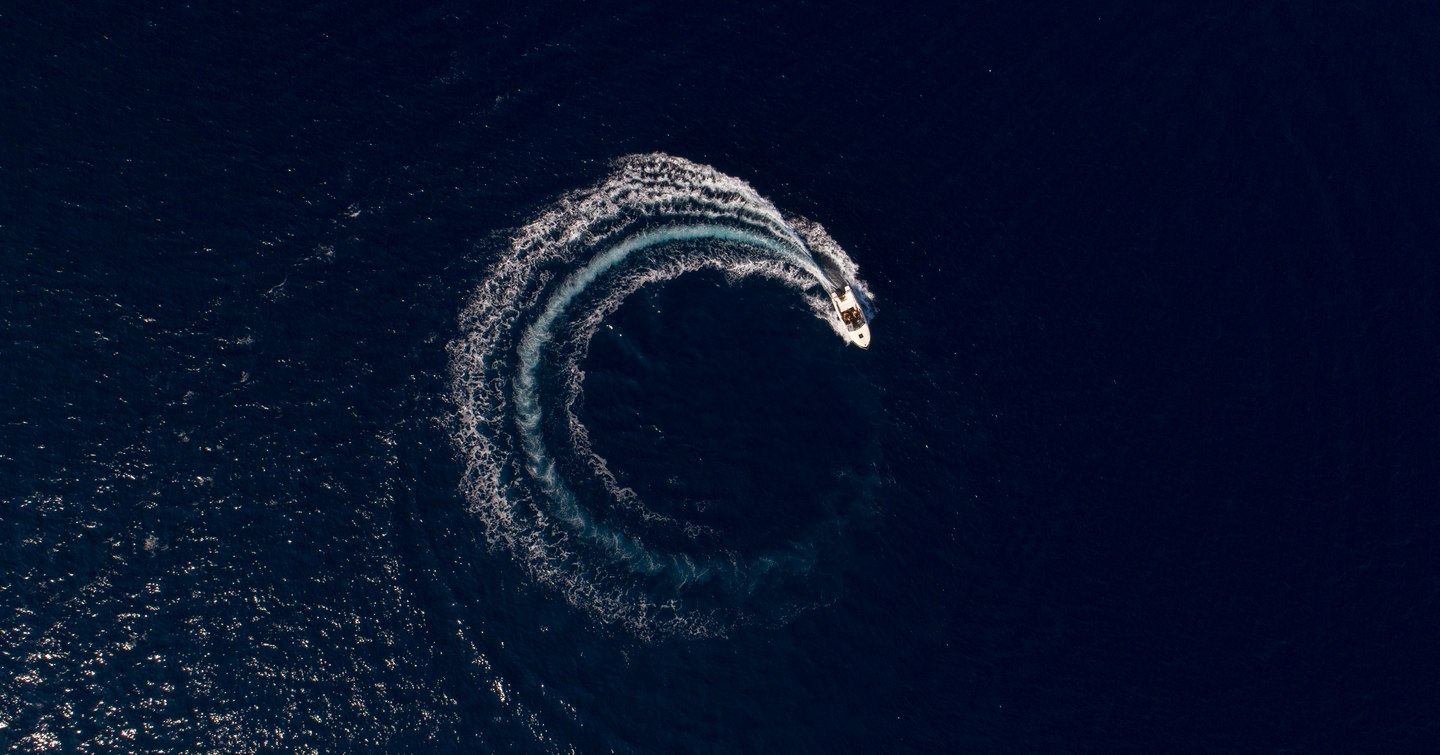 aerial view of yacht circling in international waters