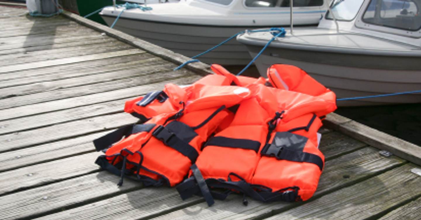 Orange life jackets on dock 