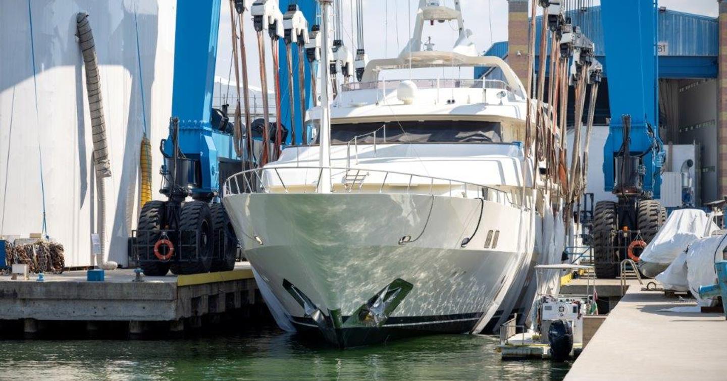 Forward view of M/Y VIANNE during her technical launch, surrounded by crane and construction shed in background.