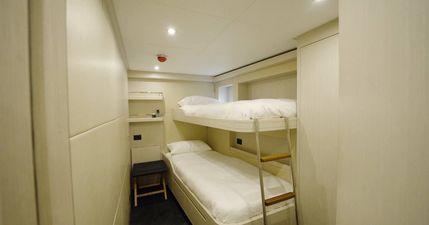 Crew cabin near galley with bunk beds aboard the Gulf Craft Majesty 100 Terrace
