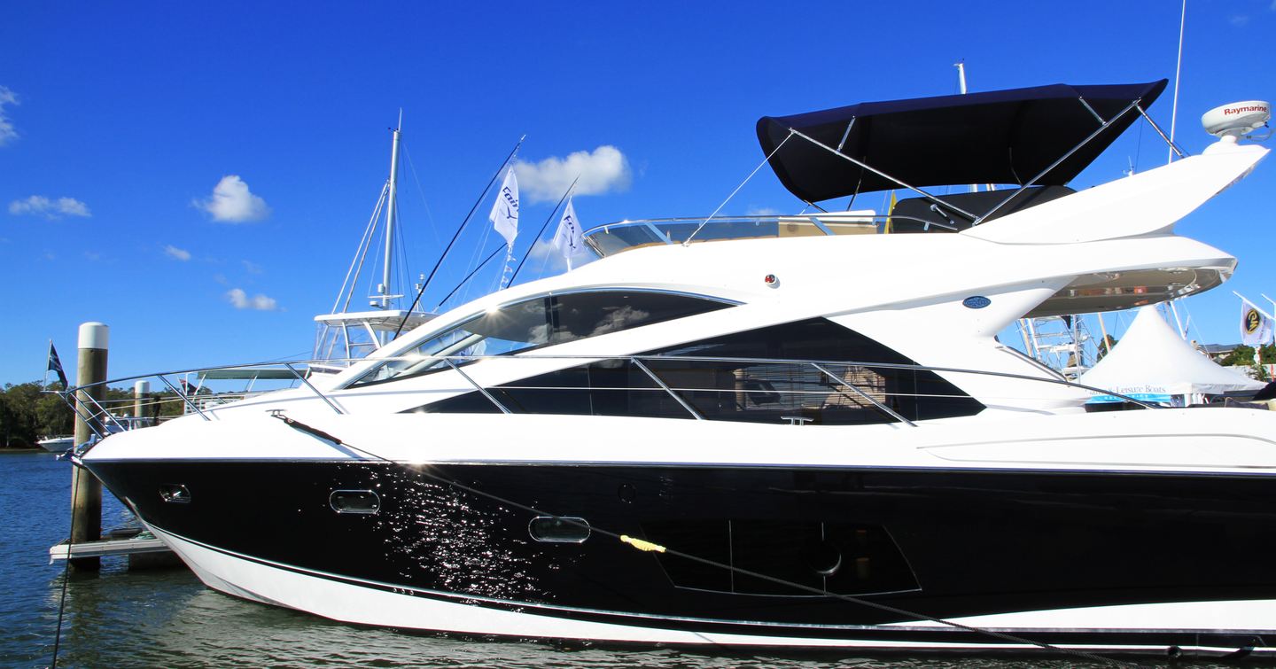 Side view of motor yacht berthed at Sanctuary Cove, Australia.