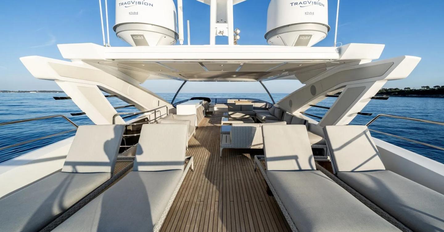 Motor Yacht Triple Eight flybridge with sun loungers and open seating area