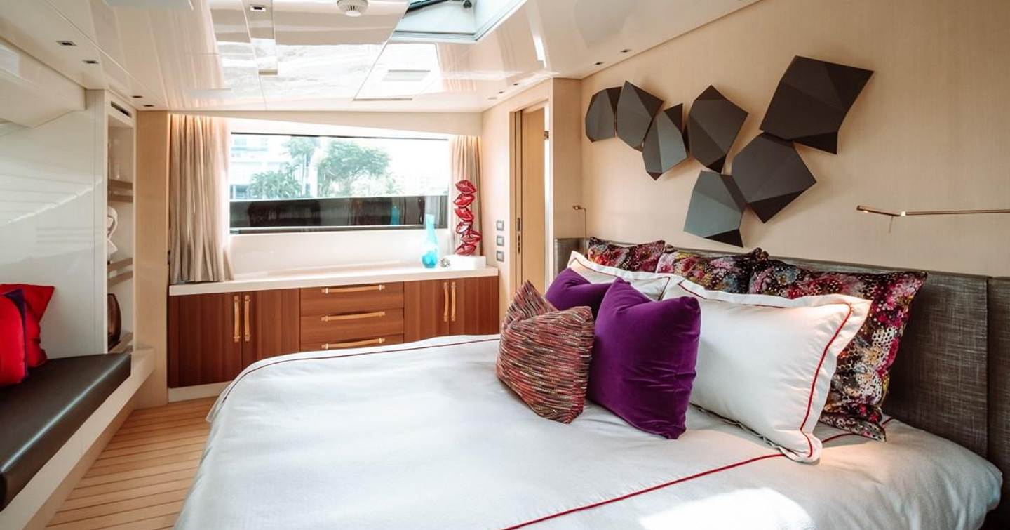 Owner's cabin on motor yacht Fifty Shades with king sized bed sofa and colourful furnishings