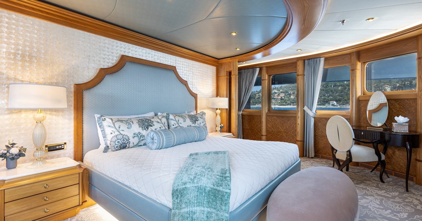 Owner's cabin on motor yacht Vibrance with King-sized bed and vanity