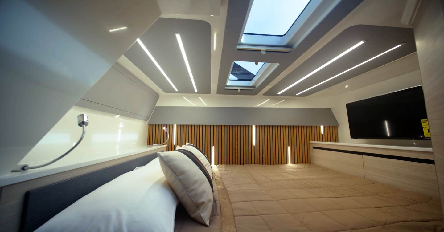 Aquila 45 Sport cabin interior with large double bed, skylights above and modern lighting, showing single-cabin layout