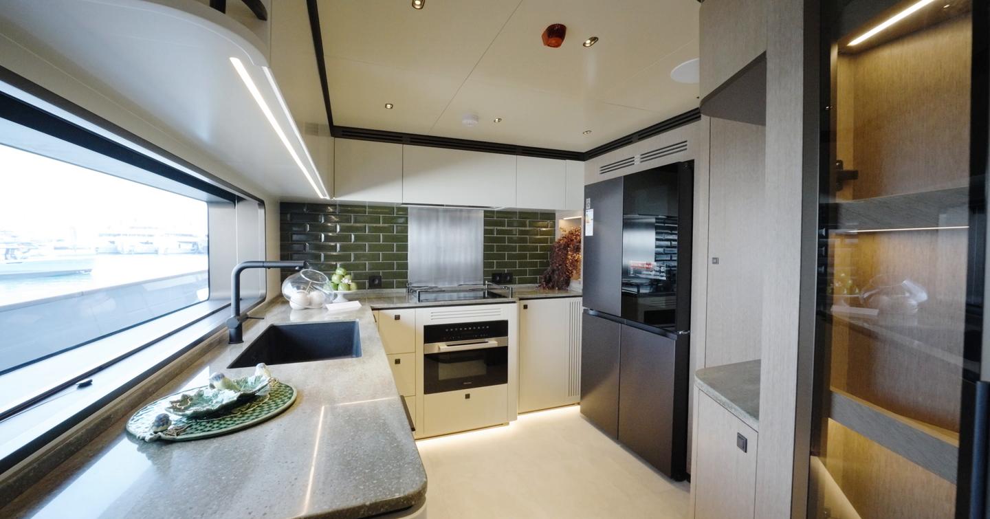 Sirena 118 main deck galley with green metro tiles, induction hob and large window