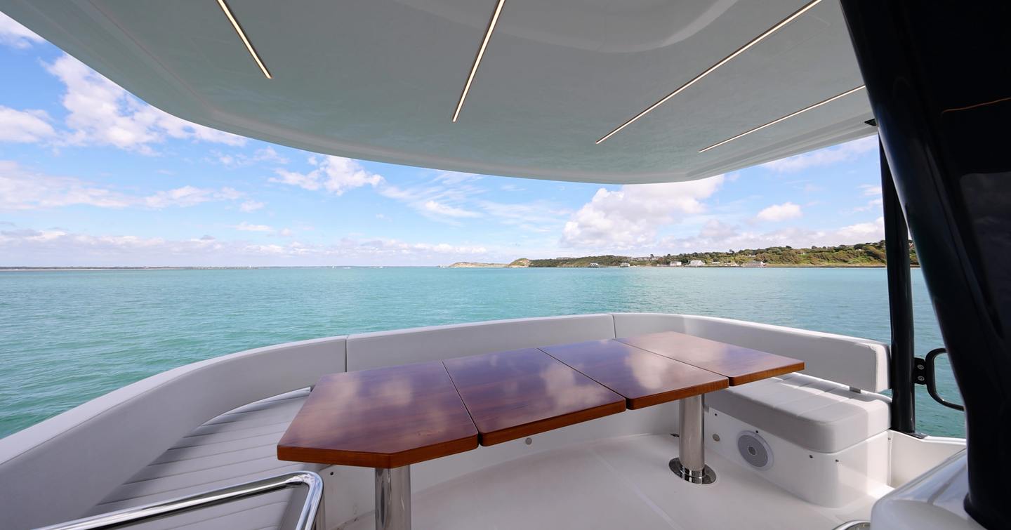 Sirena 48 flybridge dining area beneath the hardtop