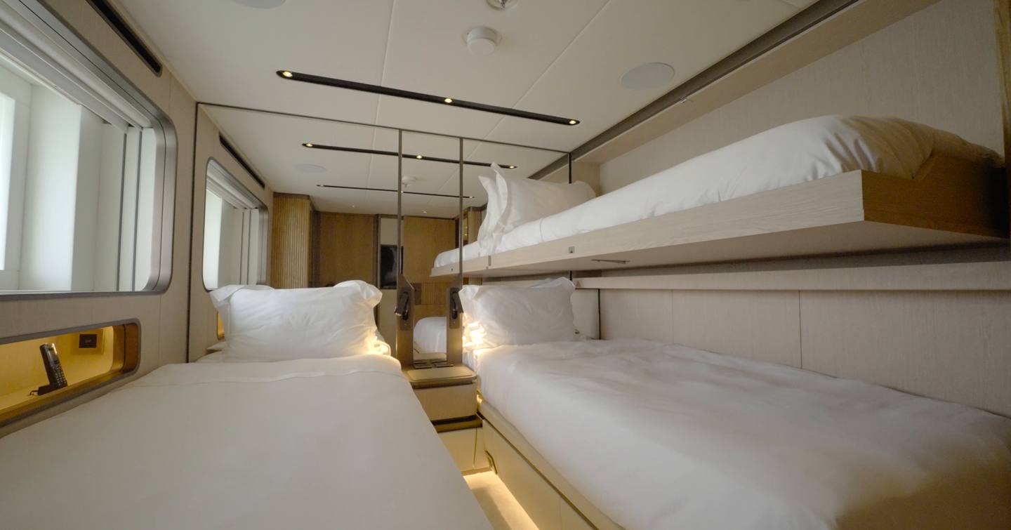 Twin guest cabin aboard the Gulf Craft Majesty 145 with Pullman berth, hull windows and mirrored wardrobe