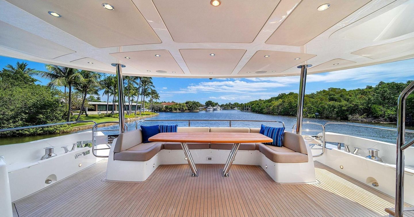 Motor Yacht Aqua Vista aft deck with shaded U-shaped seating