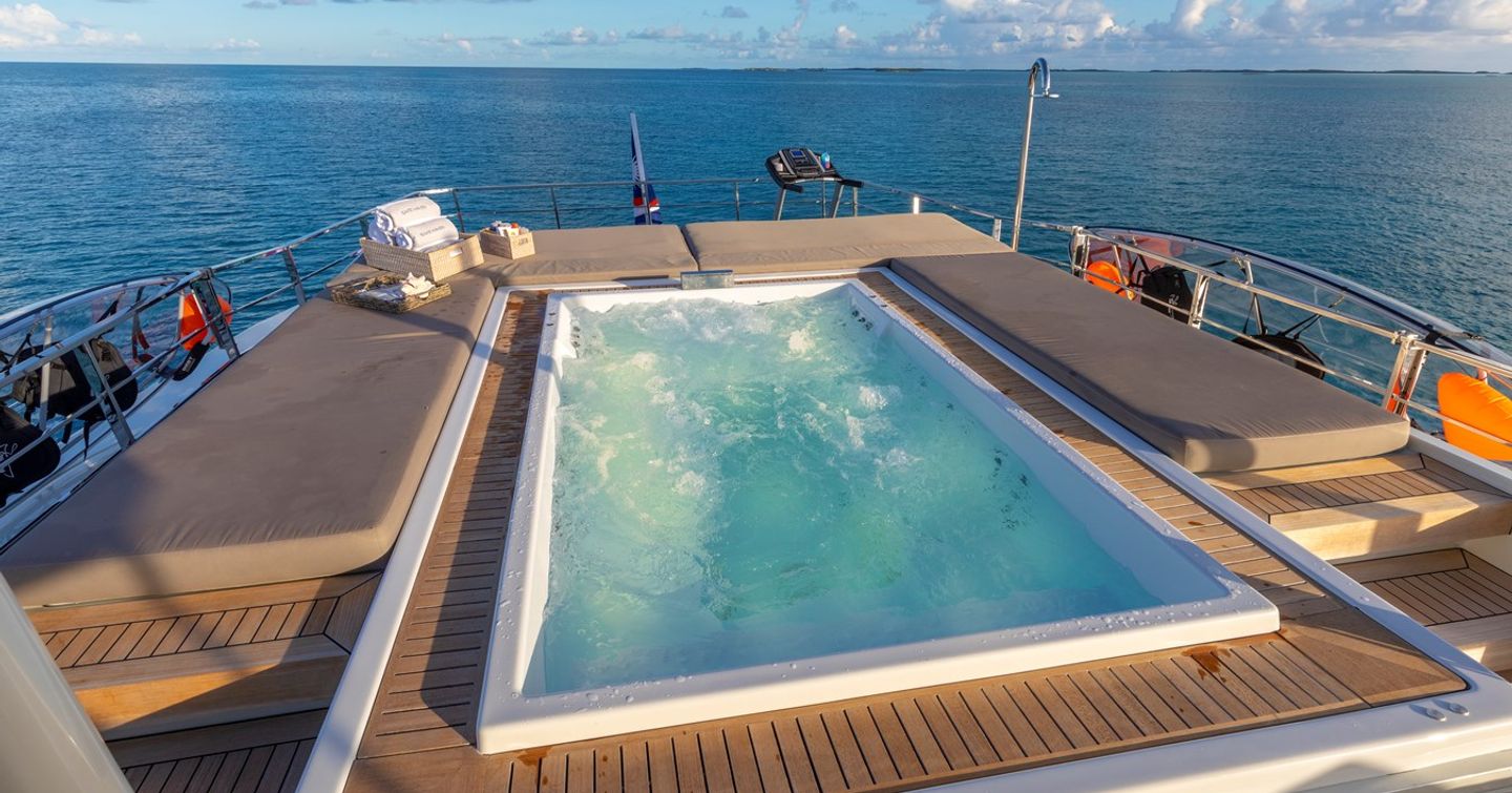 Superyacht Safe Haven upper deck spa pool surrounded by sunpads 