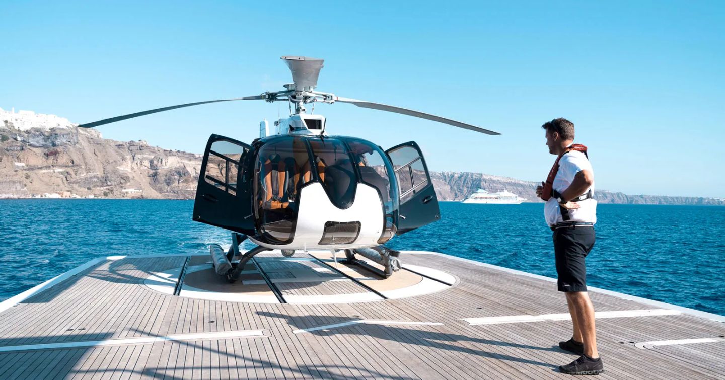 Helicopter landing on helipad on explorer yacht Flying Manta