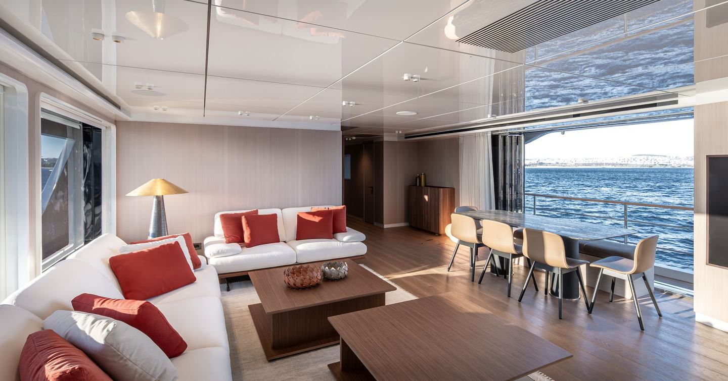 Superyacht Tuccini main salon with white sofas and dining area 