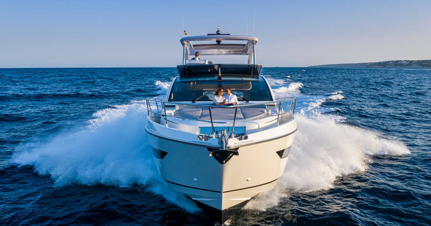 Onwards view of Pearl 62 flybridge yacht underway looking directly at the bow, surrounded by sea