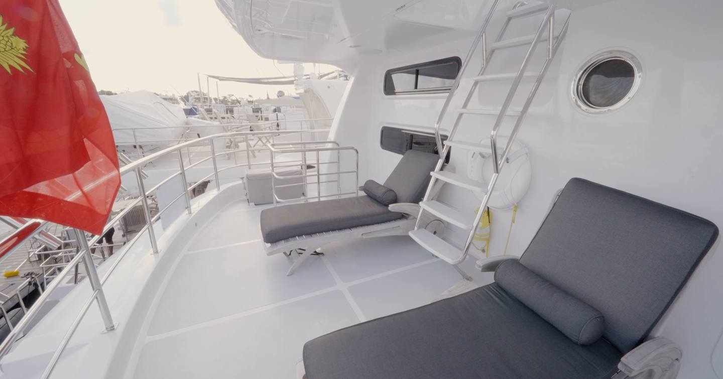 Nordhavn 75 EYF bridge deck aft lounge with sun loungers and staircase to the flybridge