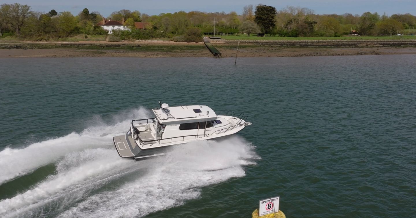 Aerial view of the Botnia Targa 32 sweeping around a marker buoy, throwing spray during YachtBuyer's £300,000 used boat race.