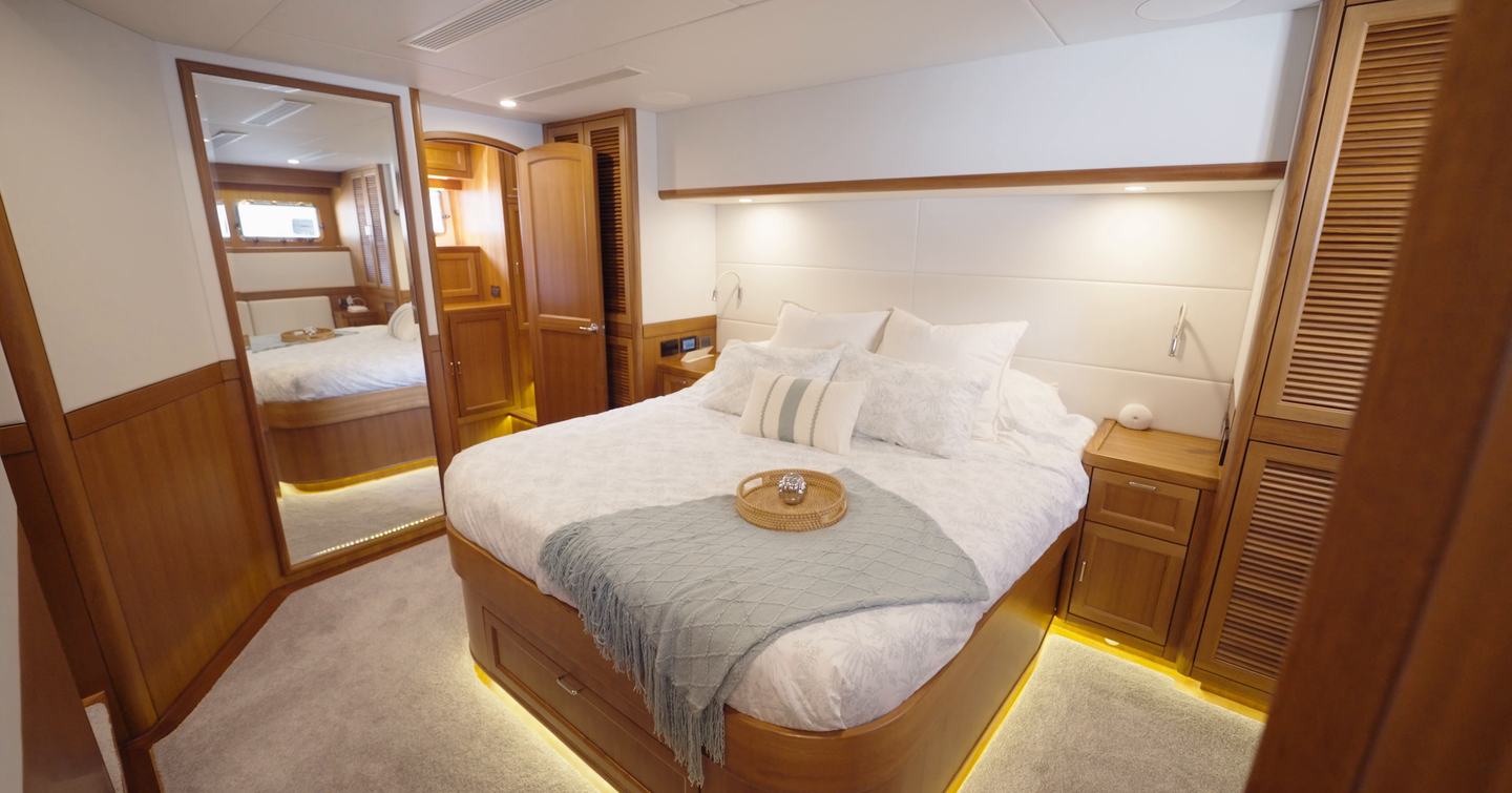 Fleming 85 full-beam owner's stateroom with island berth, seating area and ensuite access