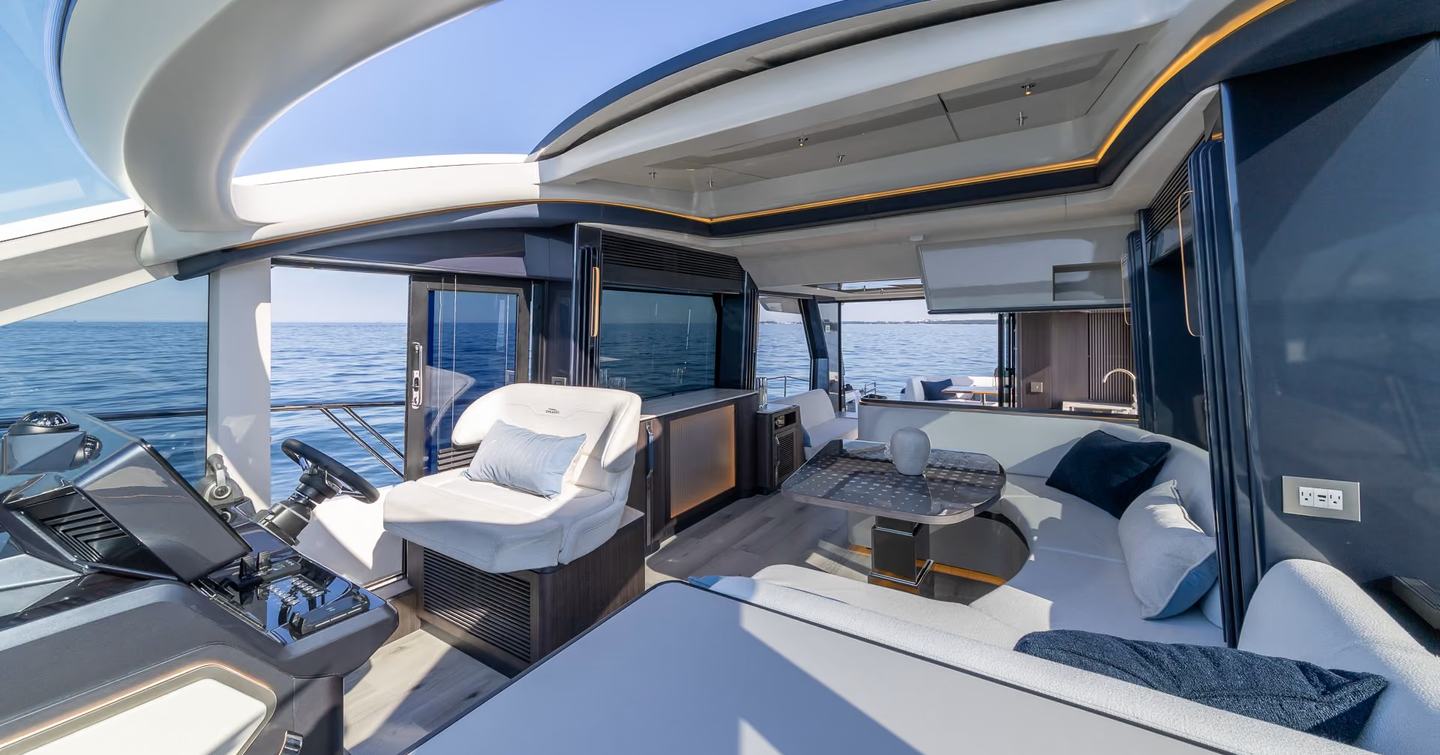 Galeon 570 SKY Motor Yacht main salon with helm station and curved white seating