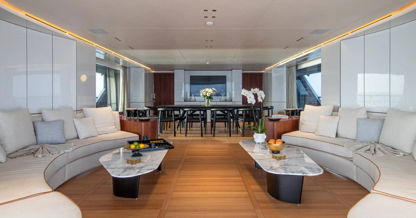 Superyacht Tosun main saloon with curved white seating and dining area