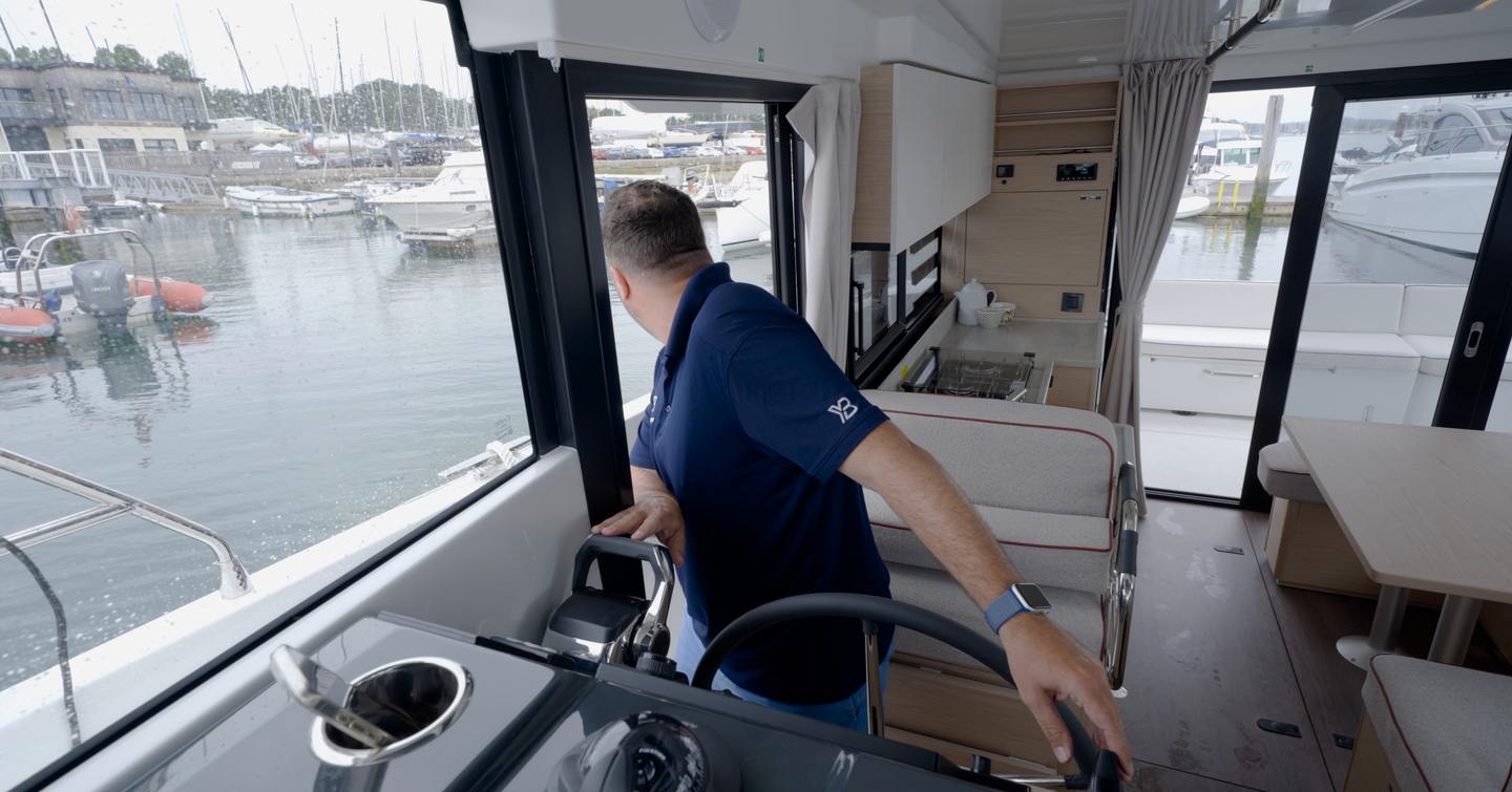 Jack Haines using the lower helm side door during a berthing manoeuvre on the Beneteau Swift Trawler 37 Fly