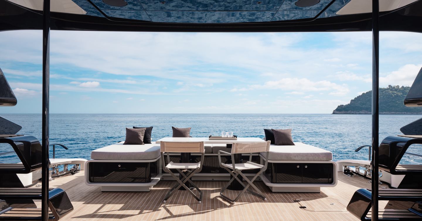 AB Yachts AB 95 motor yacht aft deck with U-shaped seating and deck chairs