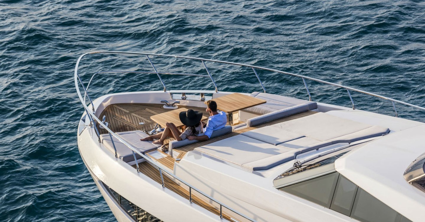 Couple at bow of Ferretti yacht