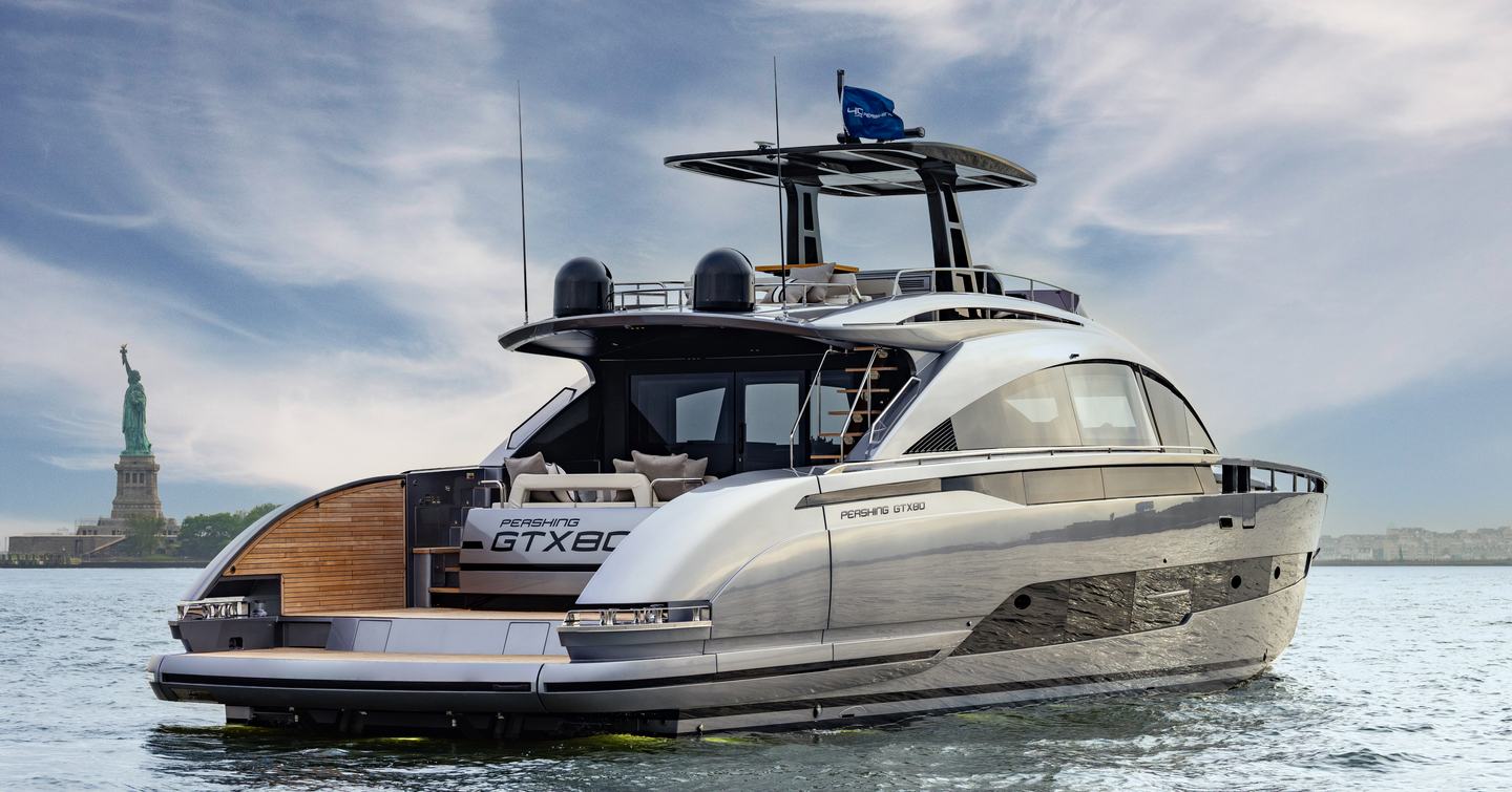Pershing GTX80 motor yacht with Statue of Liberty under way