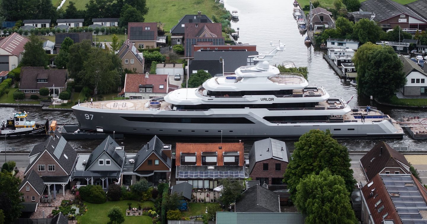 Port side of Feadship 80m Explorer Yacht Valor making her way through the dutch canals