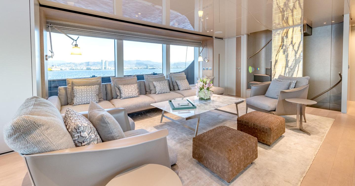 Motor yacht Speranza II's main saloon with cream sofas and coffee table