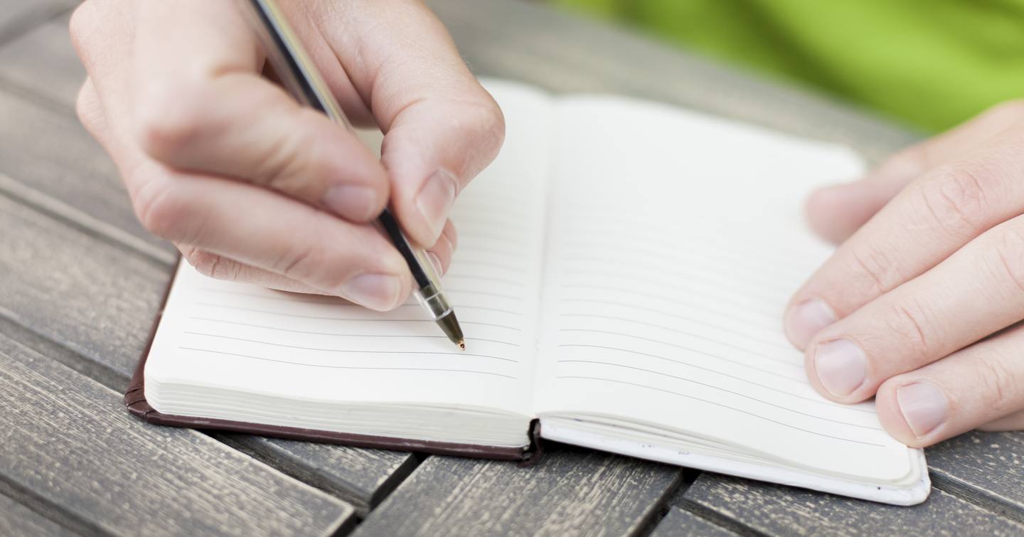 Person writing in log book